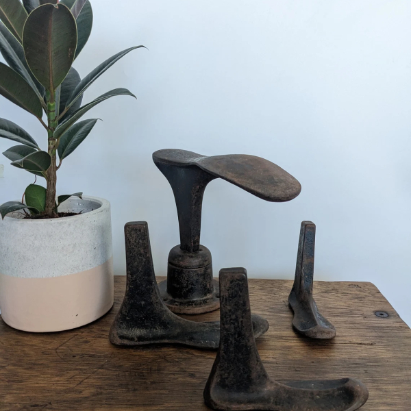 Antique cast iron set of cobbler's lasts and stand