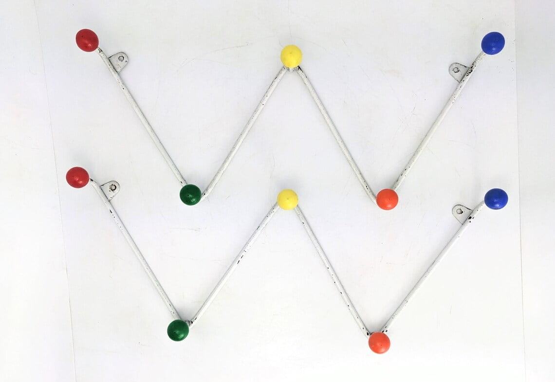 A pair of midcentury atomic design coat racks with colourful ball hooks