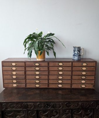 1920s antique cabinet of 24 drawers with brass pulls and label holders