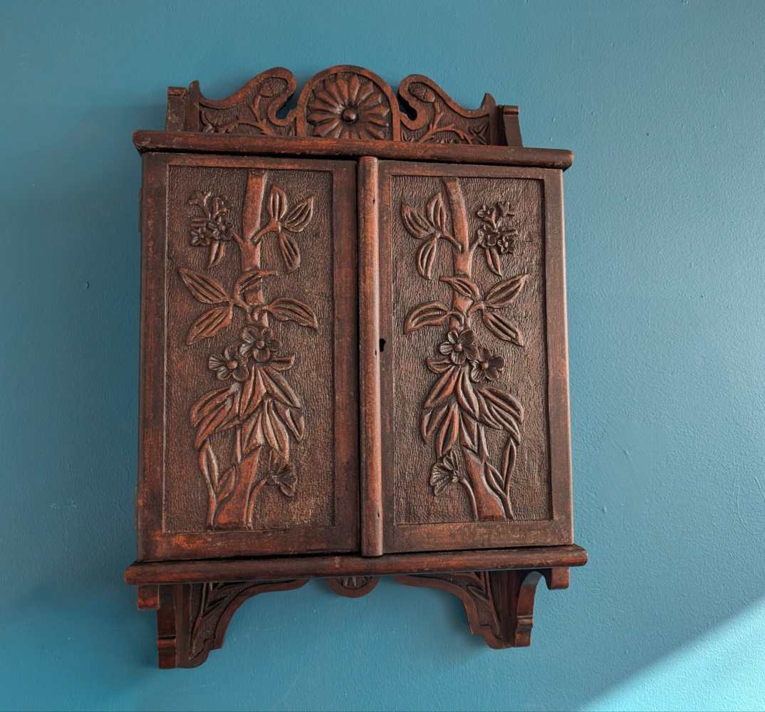 Early 1900s heavily carved wall cabinet