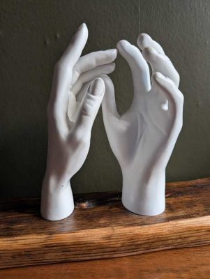 Vintage male and female shop hand mannequins on plinth