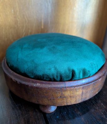 Walnut veneer footstool reupholstered in dark green velvet