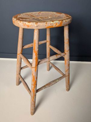 Tall orange stool with cracked paintwork