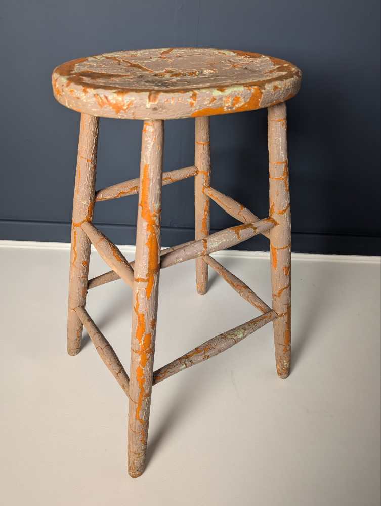 Tall orange stool with cracked paintwork