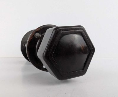 Pair of bakelite hexagonal door knobs with rod and backplates