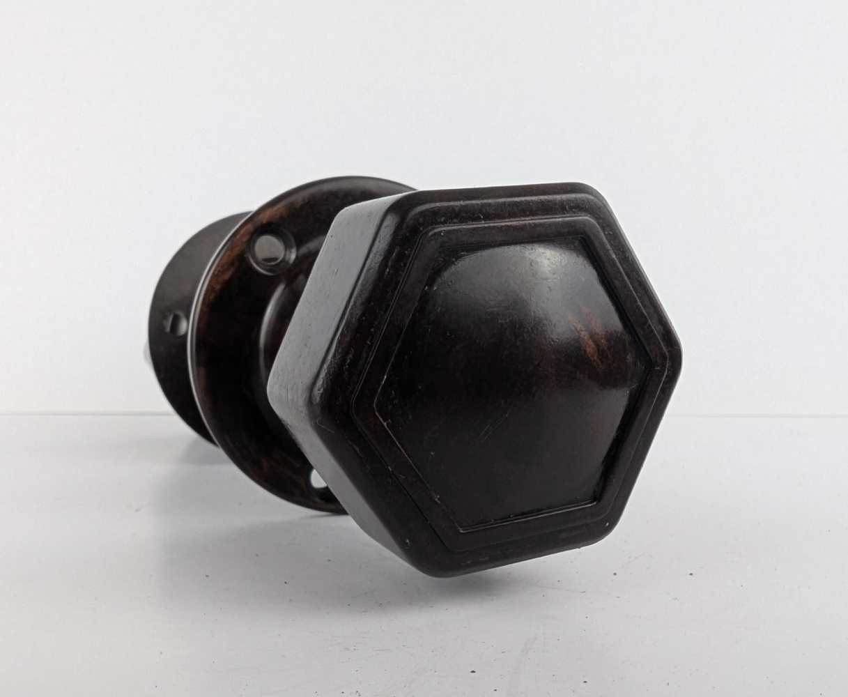 Pair of bakelite hexagonal door knobs with rod and backplates