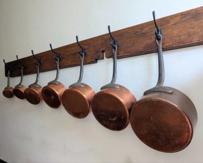 Set of seven antique French copper pans
