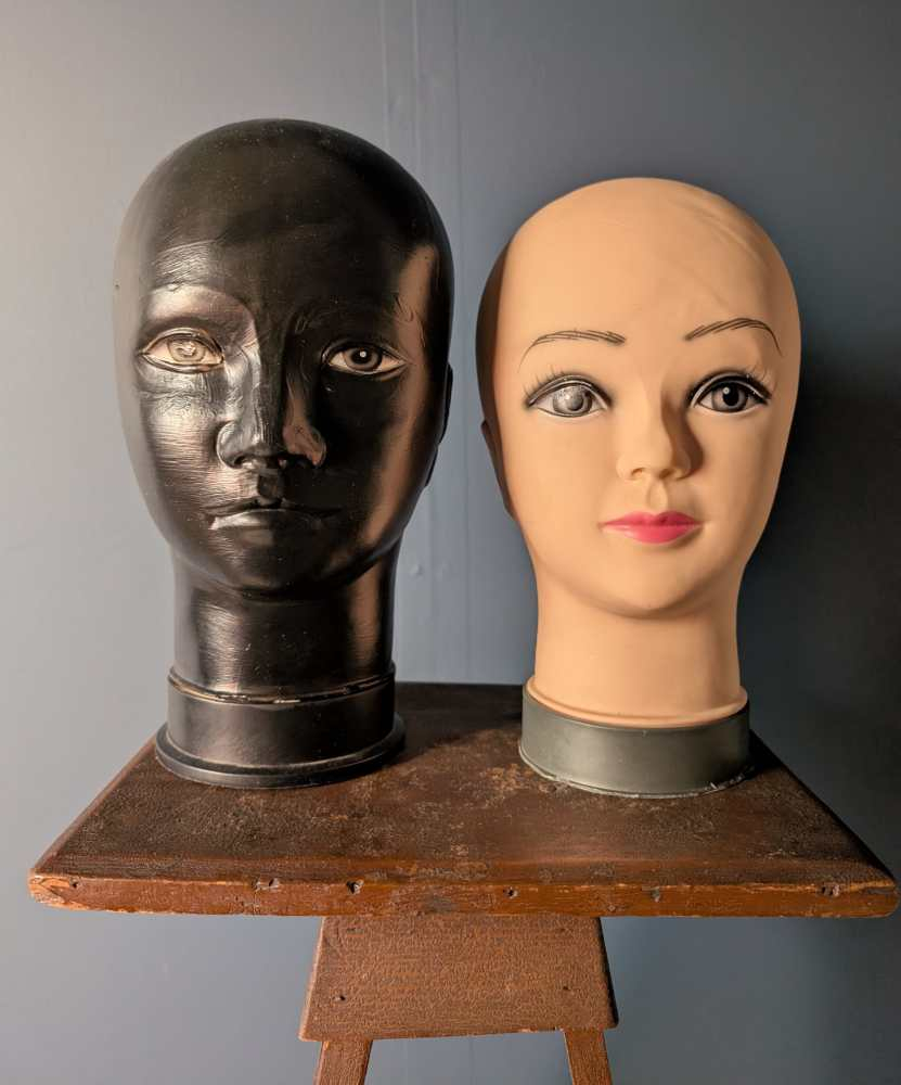 Pair of black and white mannequin heads