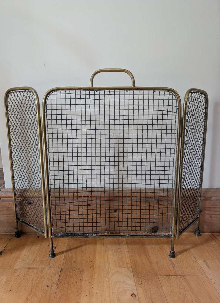 Brass c.1920s fireguard on raised feet