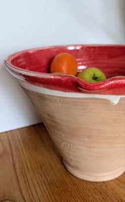 Tall stoneware dairy bowl with red interior