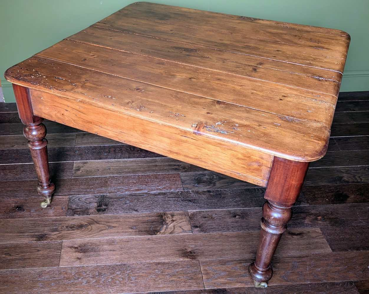 Square pine and mahogany 19th C. dining table on brass casters
