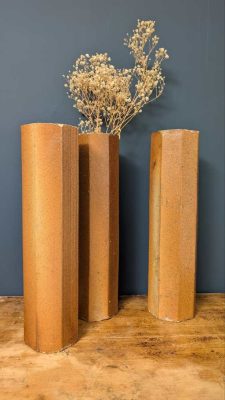 Trio of c.1940s octagonal terracotta pipes as dried flowers vases, decorative pieces